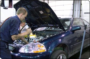 Auto detailing employee working on a car