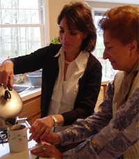 Home Health Care employee helping a patient in a kitchen